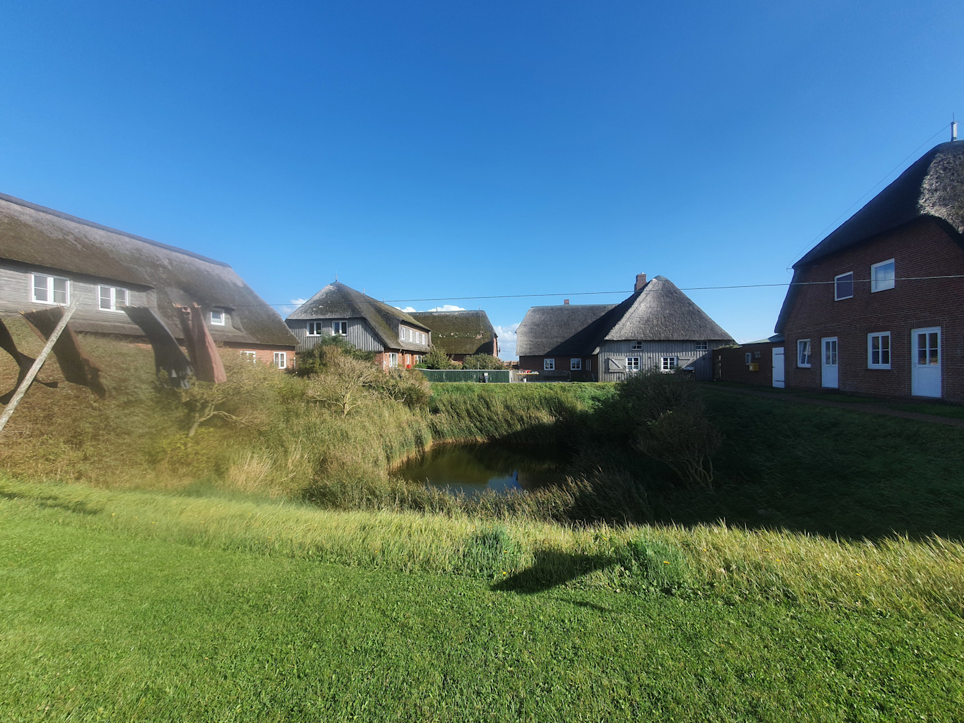 Foto gemaakt door Reinout van den Born - Gröde - De huizen van het kleine dorpje, midden op een terp op de Hallig Gröde. Er wonen 10 mensen. 